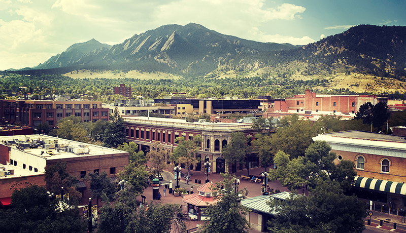 Boulder, CO as seen from the rooftop  of the City Courthouse in summer, looking down on the Pearl Street Mall and beyond to the Flatirons.