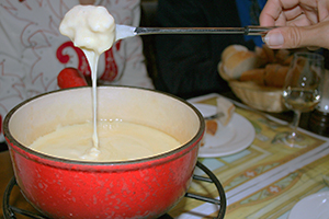 Cheese fondue at Cafe du Grutli in Lausanne, or anywhere in the country, is a quintessential culinary experience